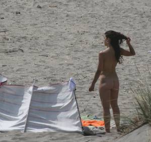 Topless girl goes full-nudist at textile beach  Almeria (Spain)-h6x556ekhx.jpg