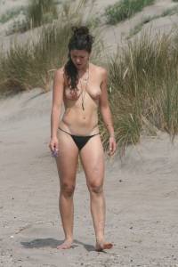 Topless girl goes full-nudist at textile beach  Almeria (Spain)o6x555psof.jpg