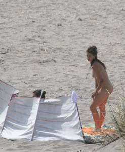 Topless girl goes full-nudist at textile beach  Almeria (Spain)-r6x556cyz4.jpg